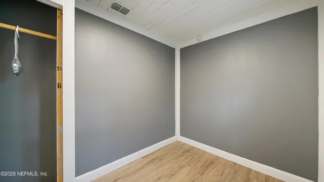 a picture of a bathroom with a white wall