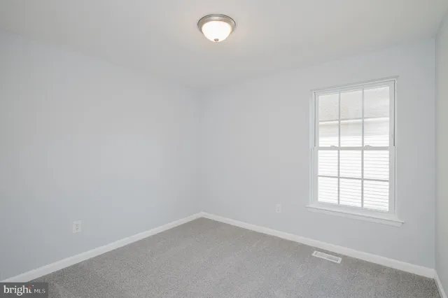 an empty room with a empty space and window