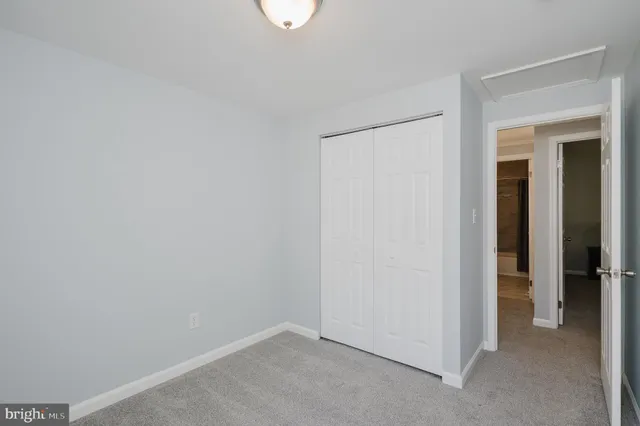 an empty room with windows and vanity