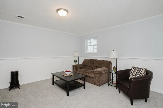 a view of an empty room with closet and a window