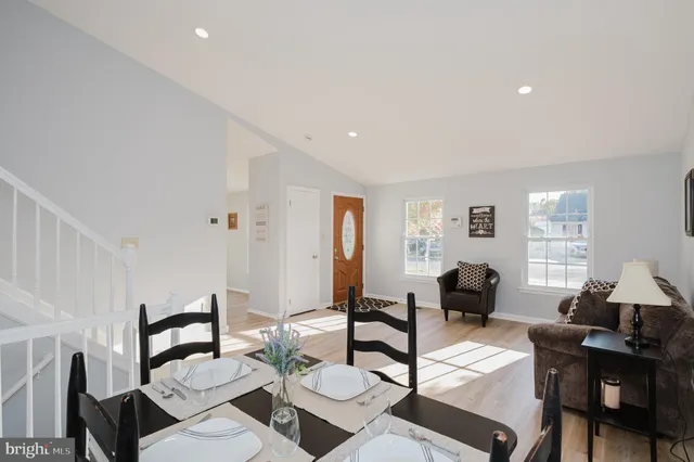 a living room with furniture and floor to ceiling windows