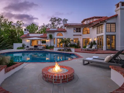 a swimming pool with outdoor seating and yard