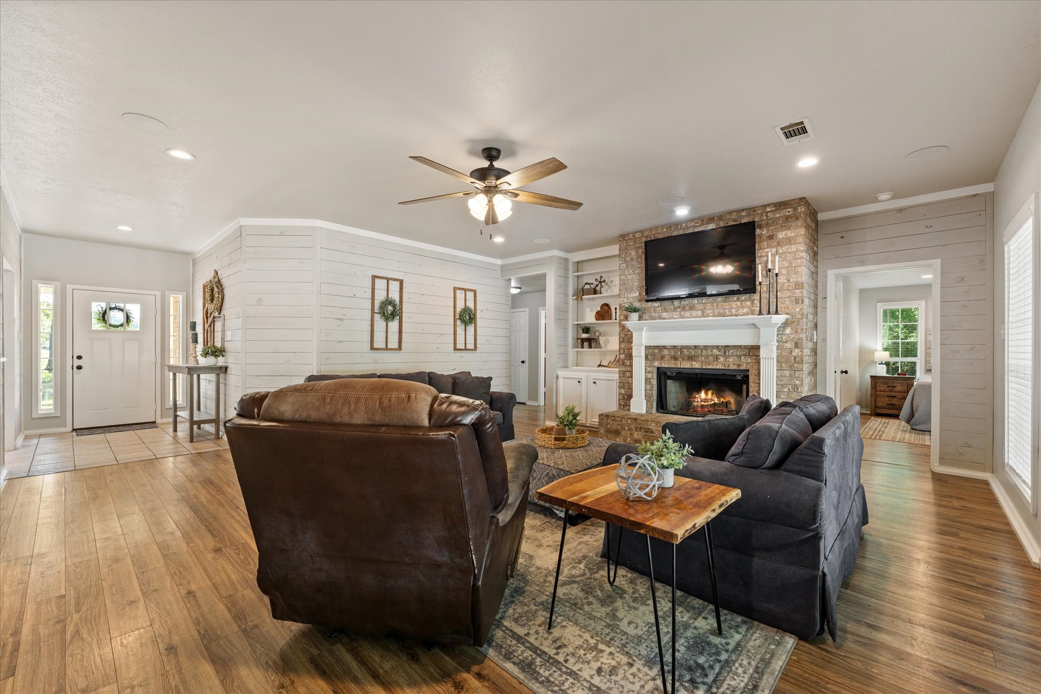 2525 Peach Creek Road College Station, TX 77845 - Photo 6 of 41 Large living room with fireplace and a wall of windows for natural lighting throughout