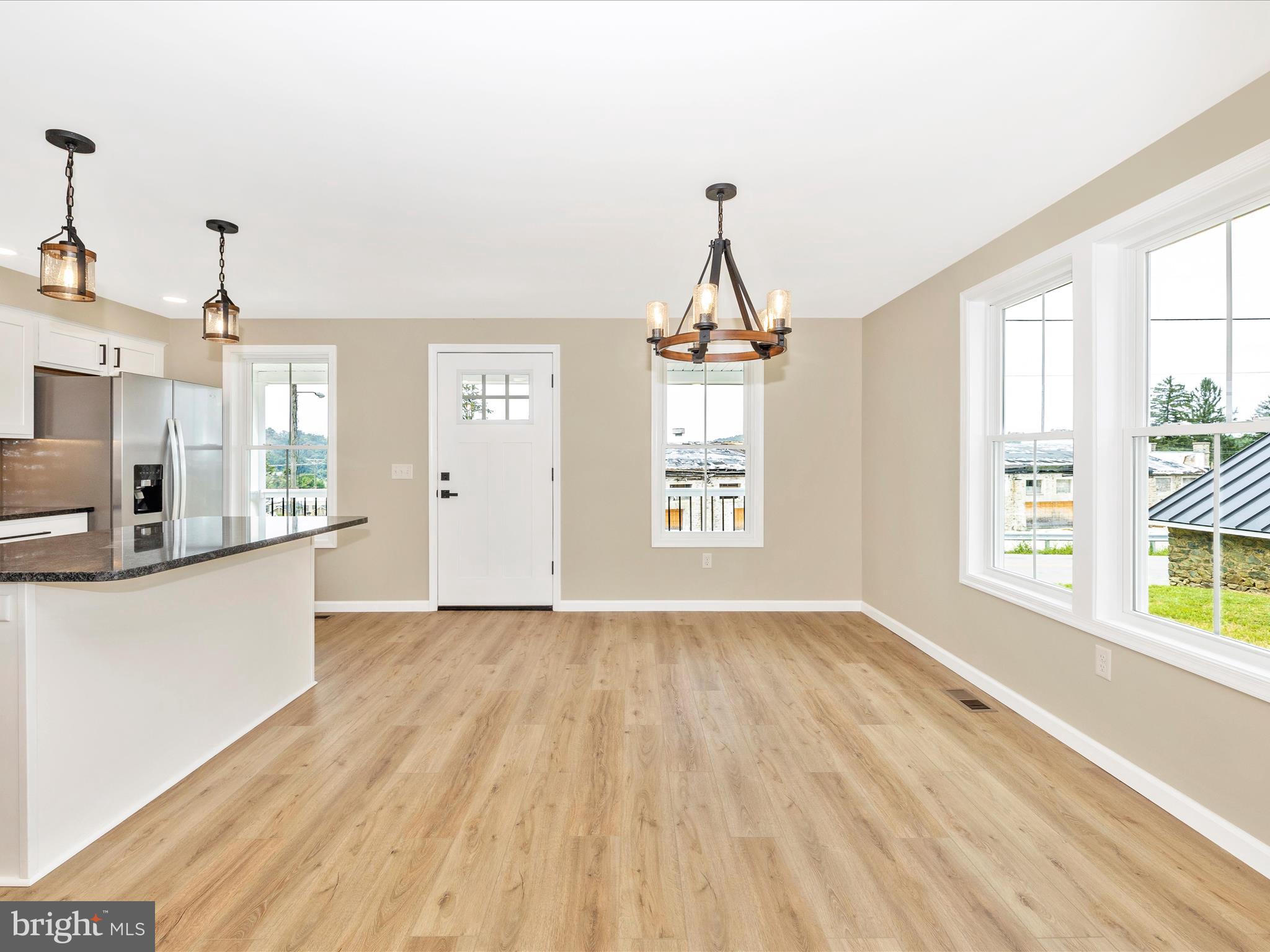 14241 Ritchie Road Cascade, MD 21719 - Photo 10 of 67 a view of a kitchen with wooden floor and windows
