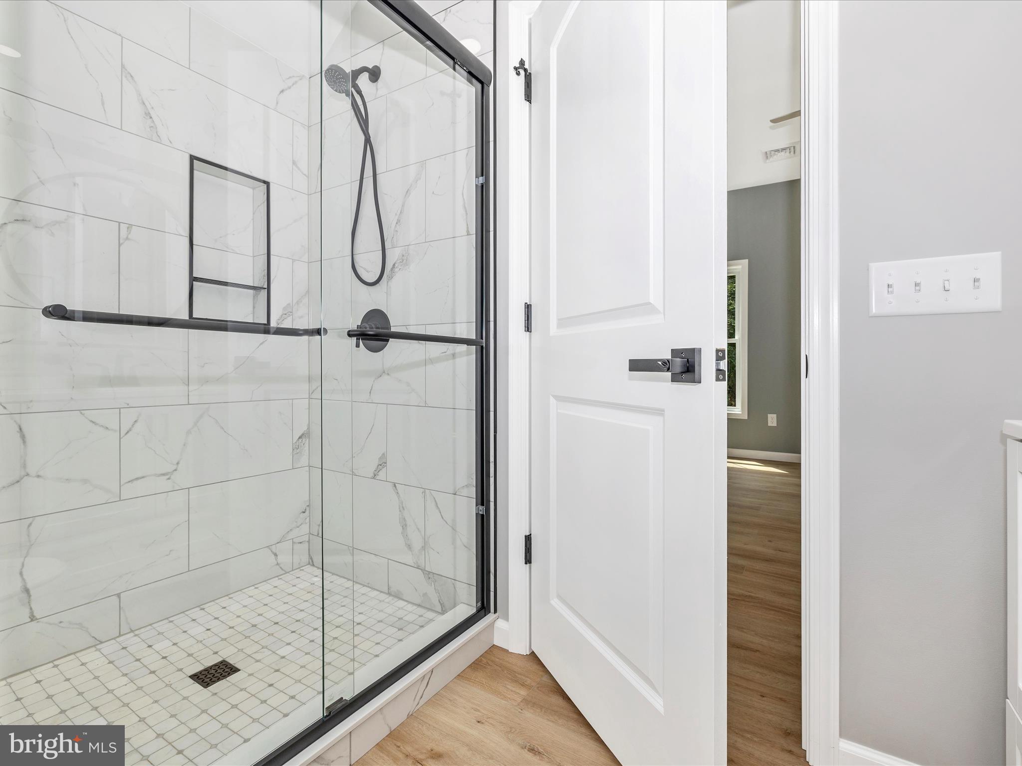 14241 Ritchie Road Cascade, MD 21719 - Photo 33 of 67 a bathroom with a glass shower door