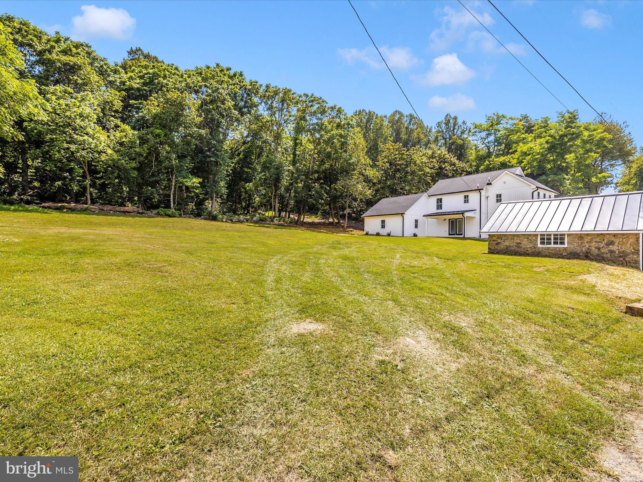 14241 Ritchie Road Cascade, MD 21719 - Photo 59 of 67 a view of a big yard with an outdoor seating