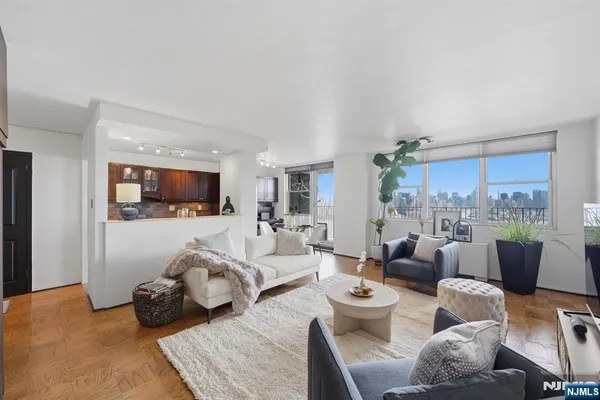 a living room with furniture and view of kitchen