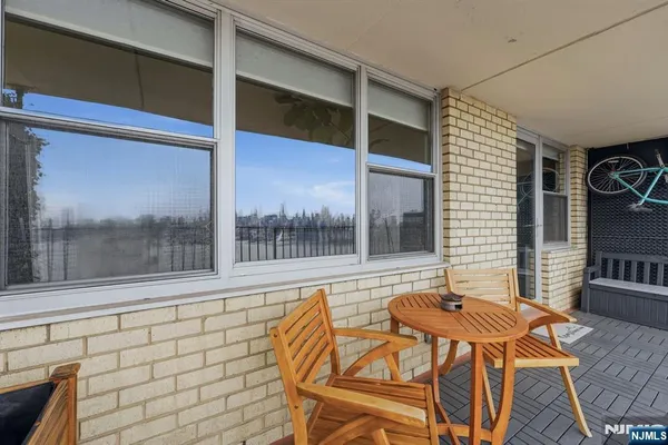 a balcony with table and chairs