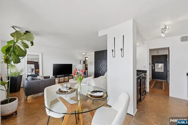 a dining room with furniture and a flat screen tv