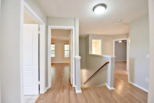 a view of a hallway with wooden floor