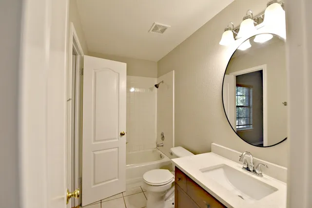 a bathroom with a toilet a sink and a mirror