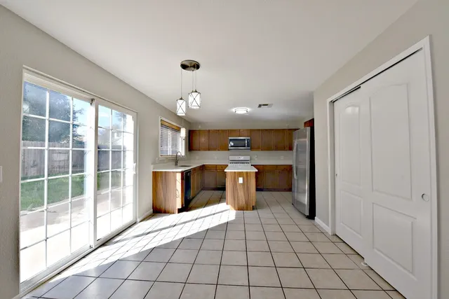a view of a kitchen with a sink and a living room