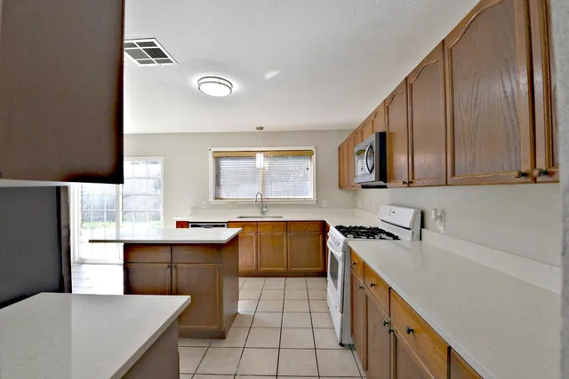 a kitchen with a sink stove and microwave