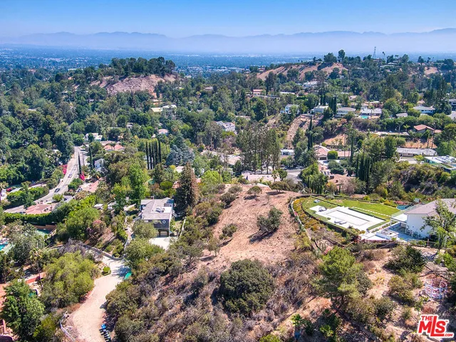 an aerial view of residential houses with city view