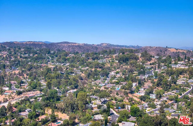 a view of a city with lush green forest