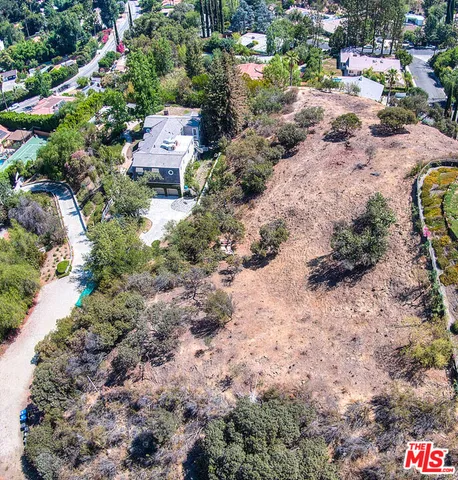 a backyard of a house with a yard and outdoor seating