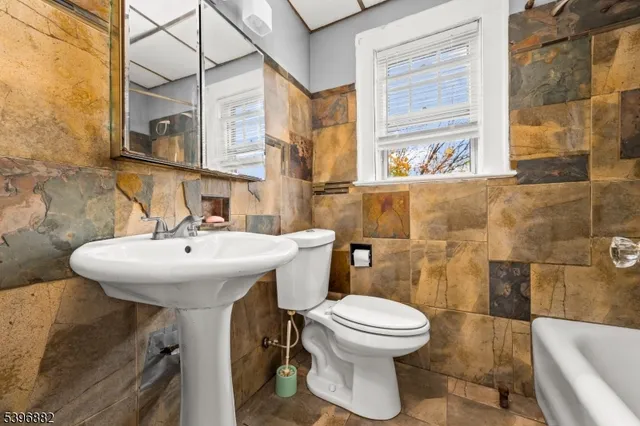 a bathroom with a sink a toilet and a bathtub