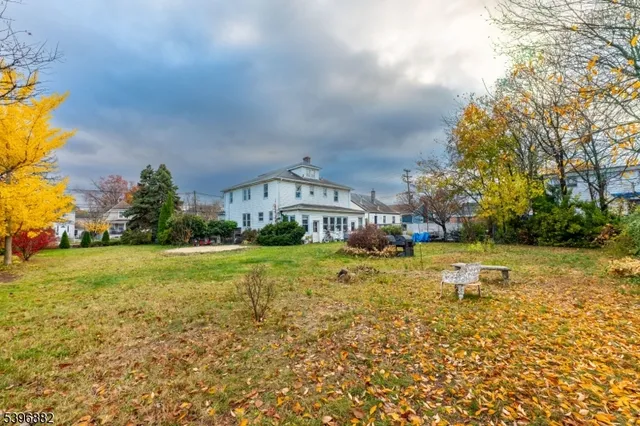 a house view with swimming pool in front of it