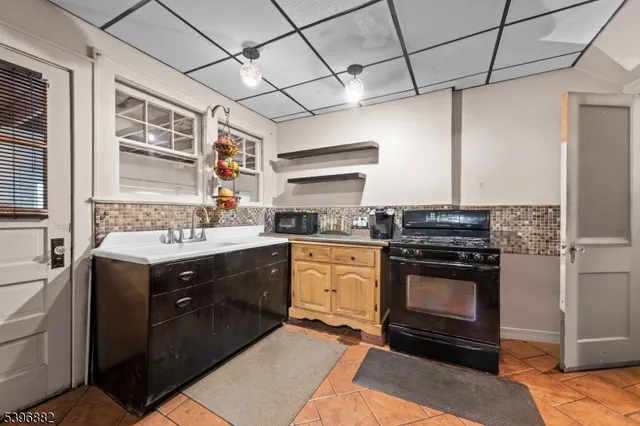 a kitchen with a stove sink and refrigerator