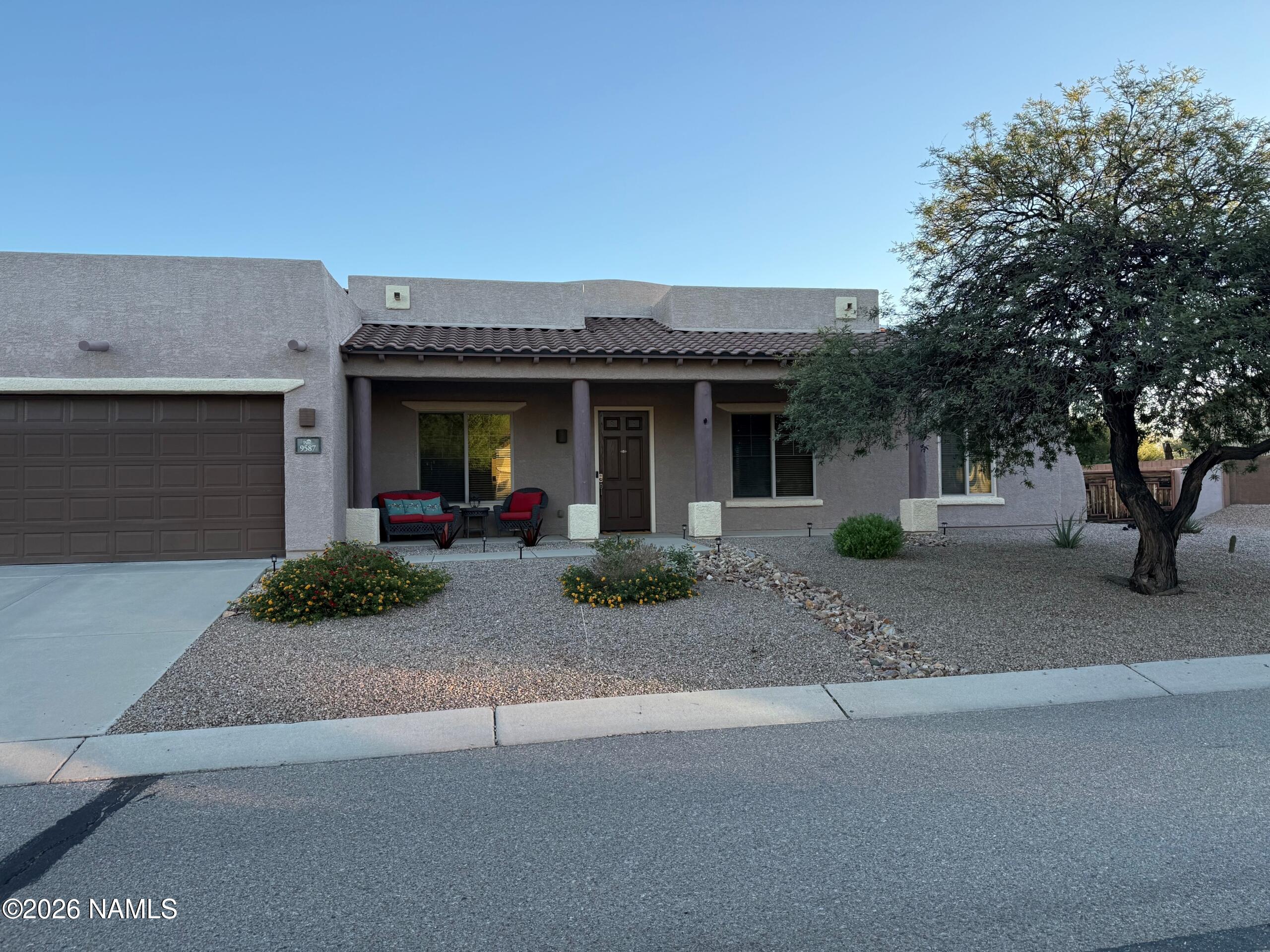 9587 South Via Bandera Vail, AZ 85641 - Photo 1 of 28 a front view of a house with garden and parking