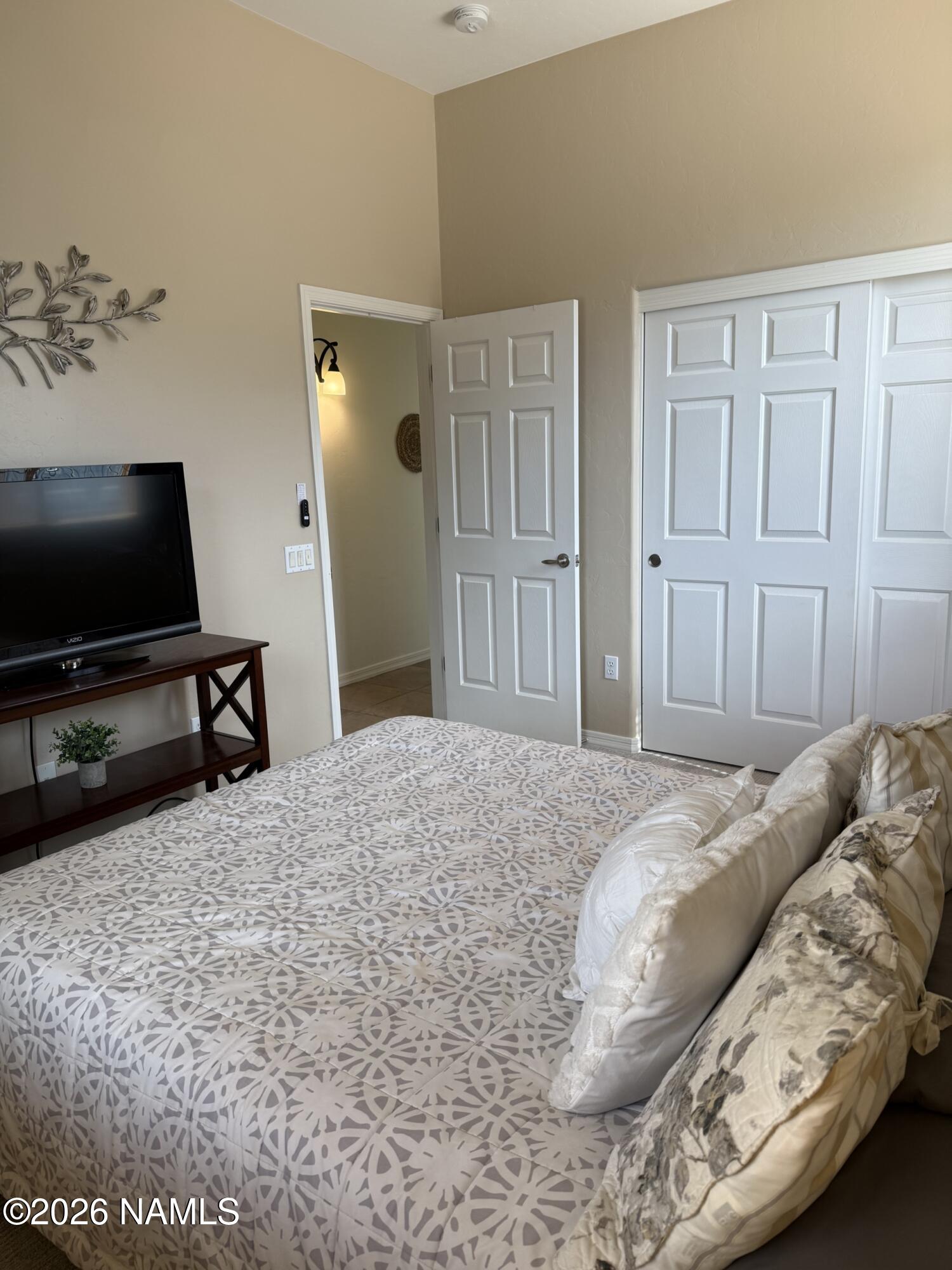 9587 South Via Bandera Vail, AZ 85641 - Photo 16 of 28 a bedroom with a bed and a flat screen tv