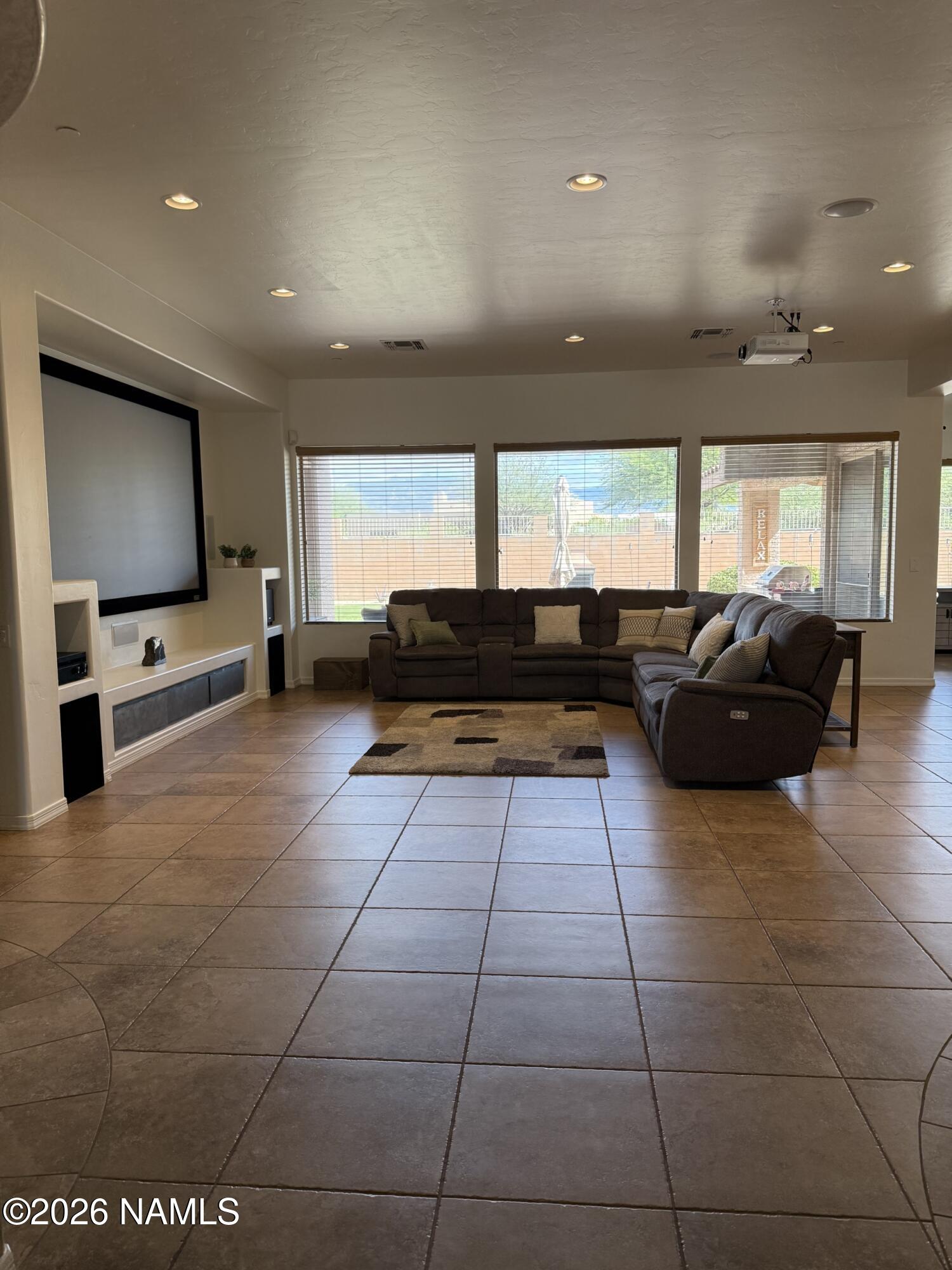 9587 South Via Bandera Vail, AZ 85641 - Photo 2 of 28 a living room with furniture and a flat screen tv