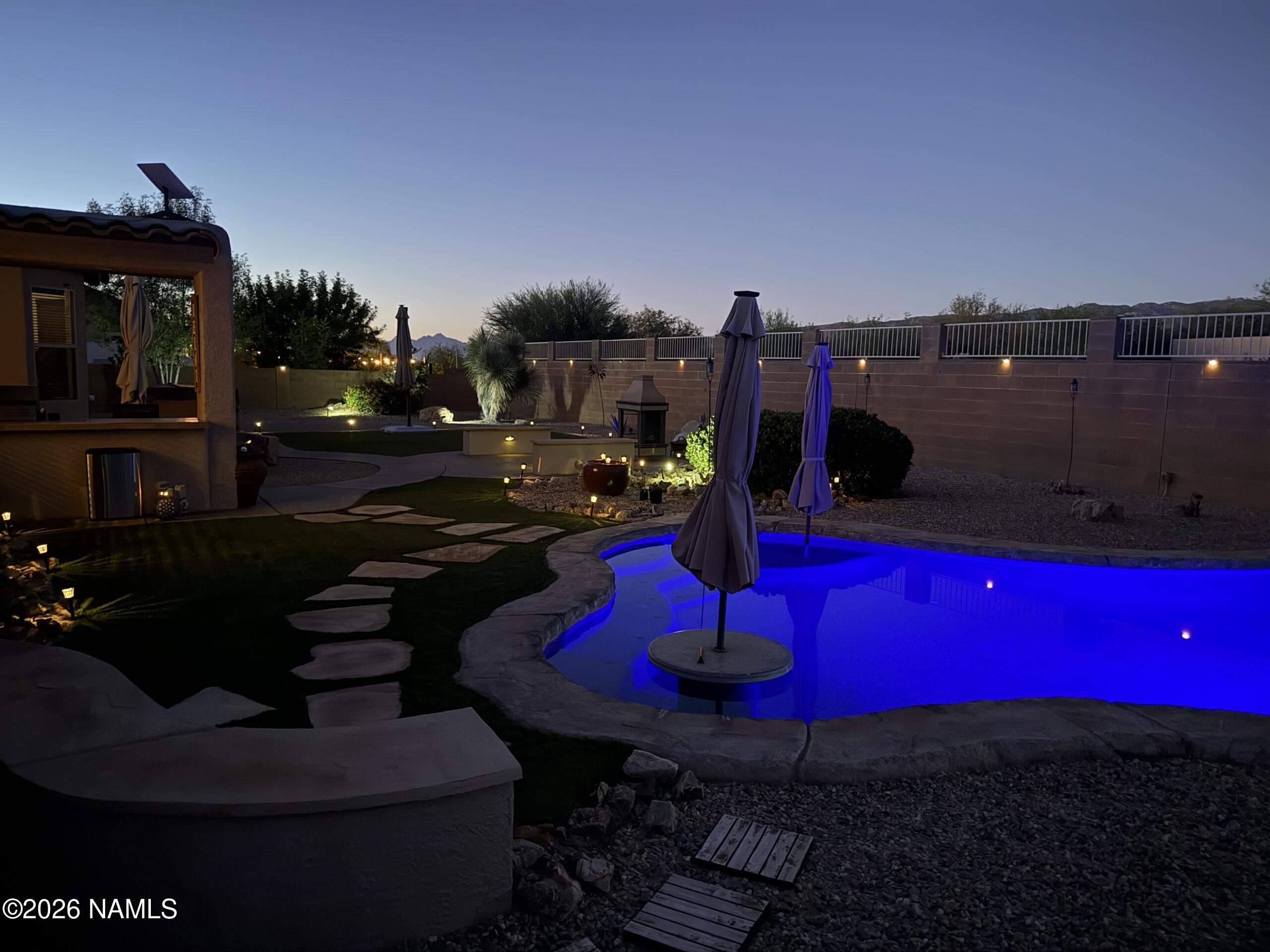 9587 South Via Bandera Vail, AZ 85641 - Photo 26 of 28 a view of a swimming pool with red chairs and table in back yard