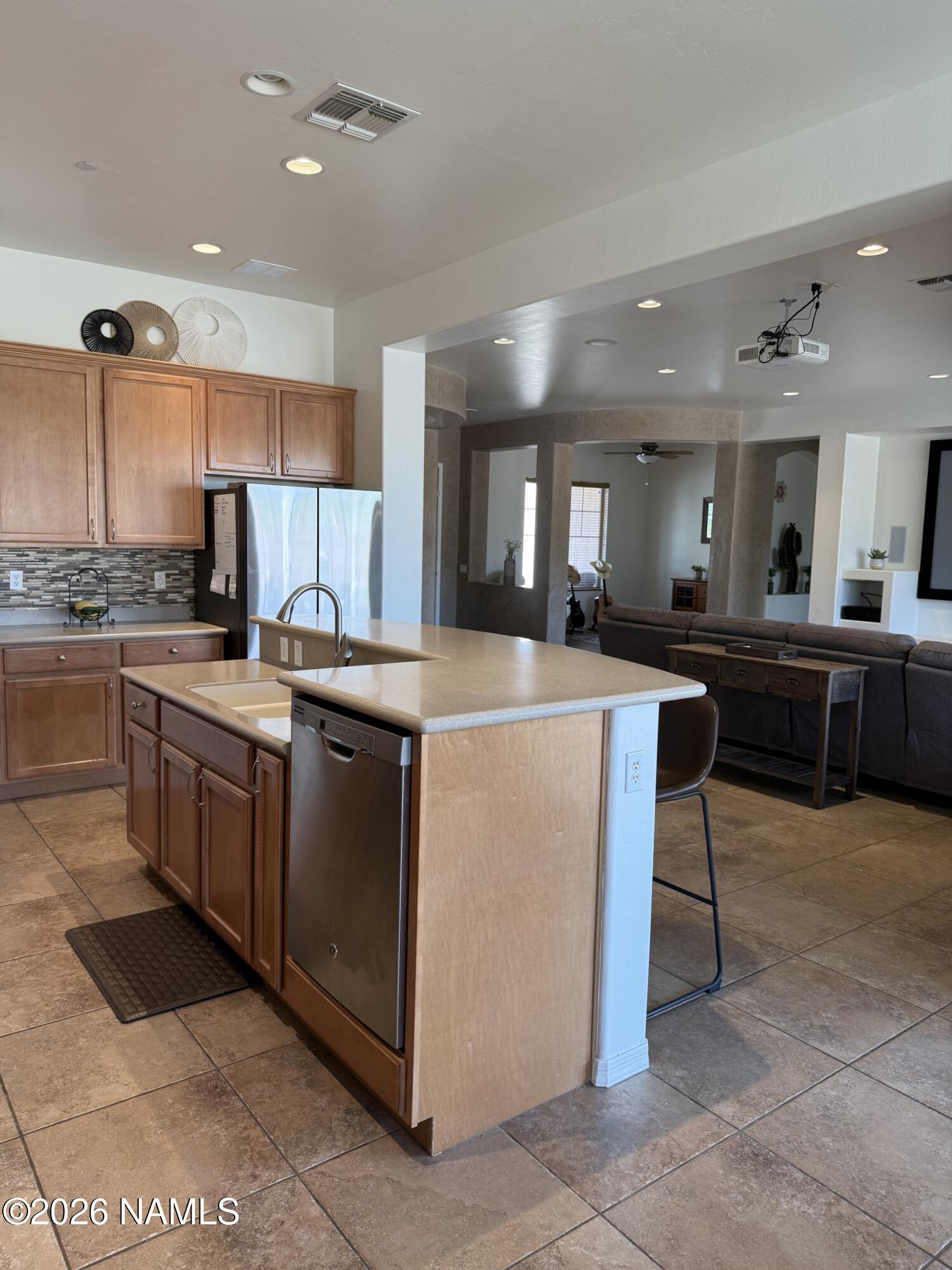 9587 South Via Bandera Vail, AZ 85641 - Photo 5 of 28 a kitchen with stainless steel appliances granite countertop a stove top oven a sink a dining table and chairs