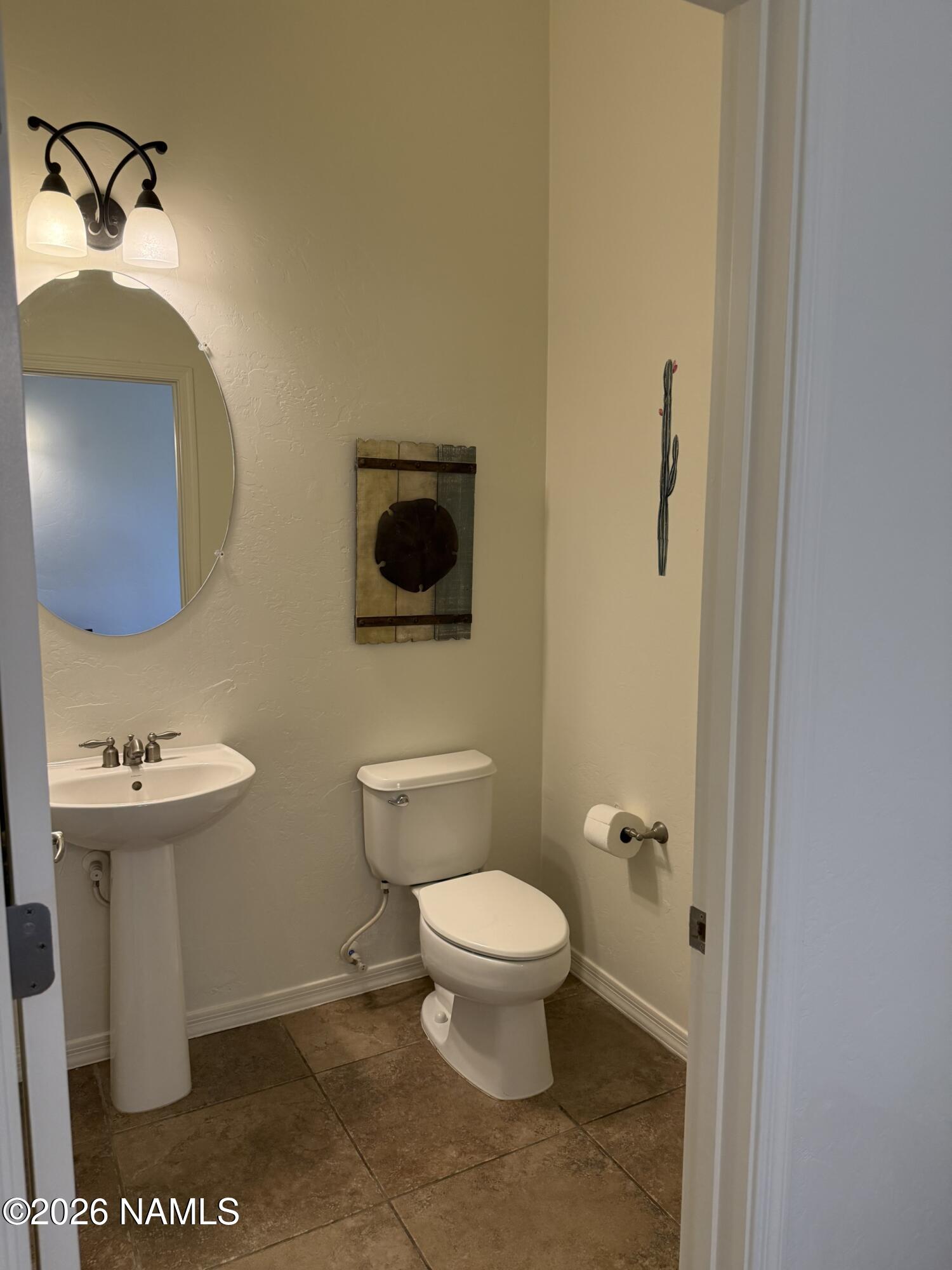 9587 South Via Bandera Vail, AZ 85641 - Photo 9 of 28 a bathroom with a toilet a sink and mirror