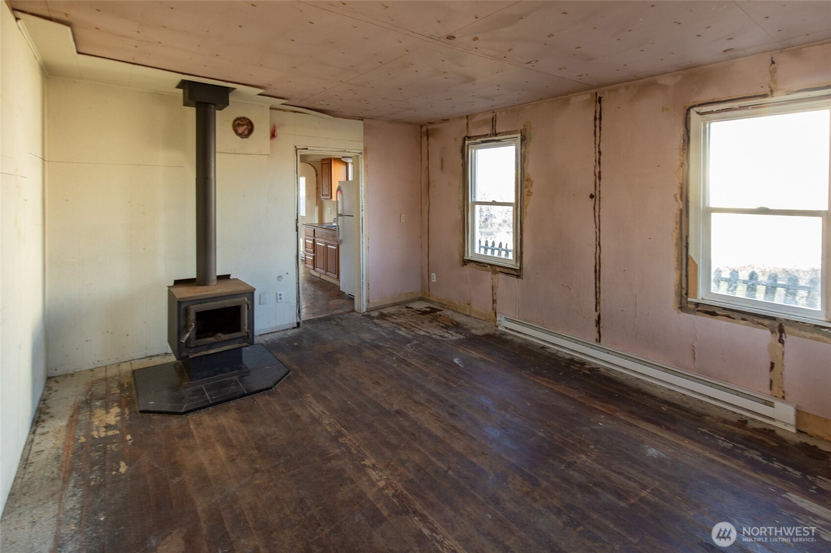 722 Jackson Street Omak, WA 98841 - Photo 3 of 11 a view of a livingroom with wooden floor and a ceiling fan