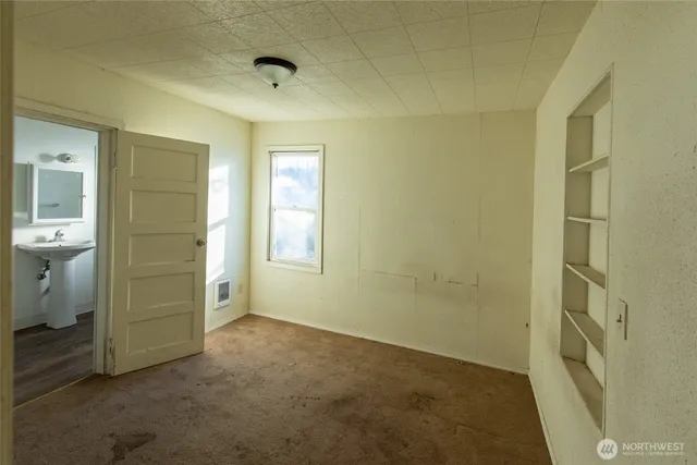 a bathroom with a sink shower and mirror