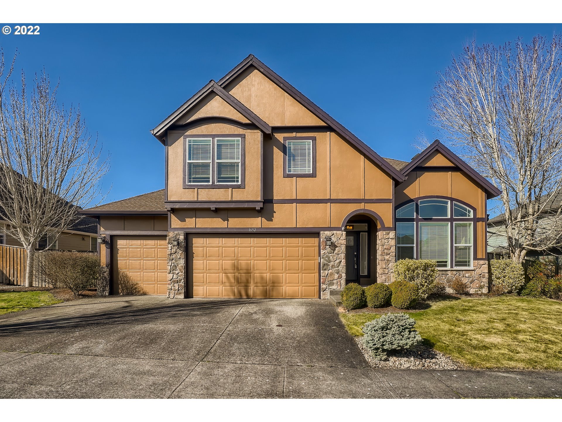 1652 South 15th Way Ridgefield, WA 98642 - Photo 1 of 32 a front view of a house with a yard and garage