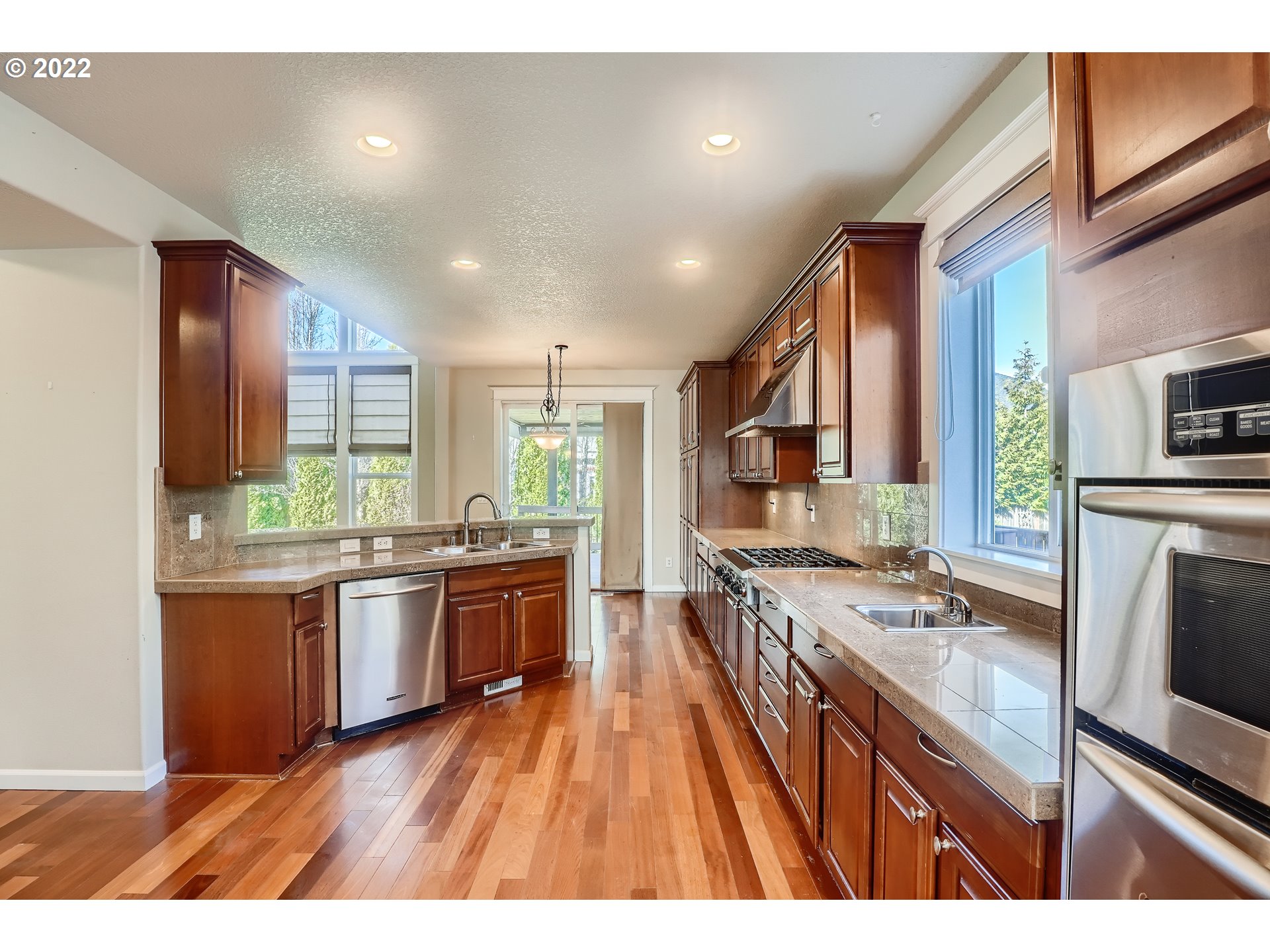 1652 South 15th Way Ridgefield, WA 98642 - Photo 12 of 32 a open kitchen with stainless steel appliances granite countertop a stove refrigerator and cabinets