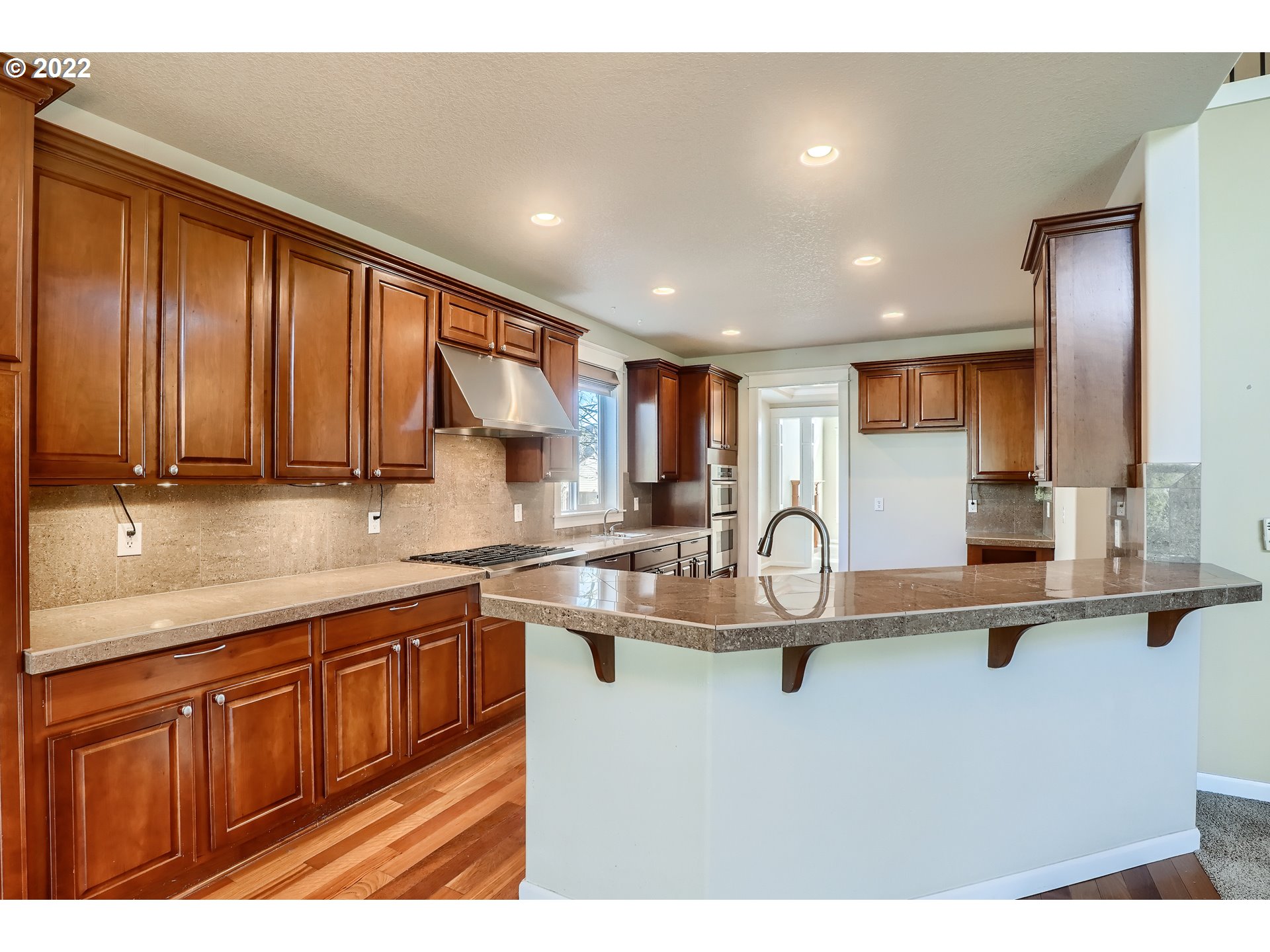 1652 South 15th Way Ridgefield, WA 98642 - Photo 13 of 32 a kitchen with kitchen island granite countertop a sink stainless steel appliances and cabinets