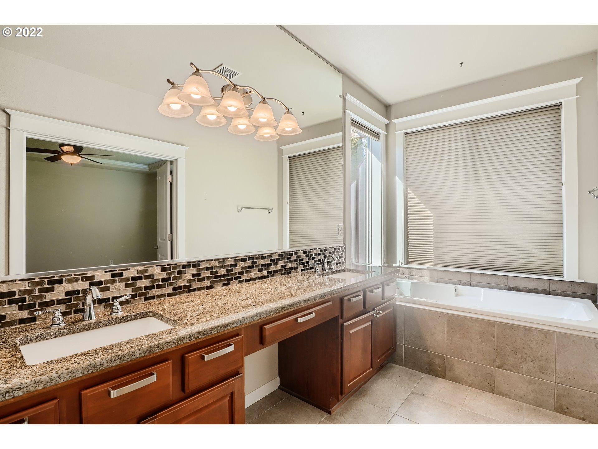 1652 South 15th Way Ridgefield, WA 98642 - Photo 21 of 32 a bathroom with a sink vanity granite tub and a large mirror