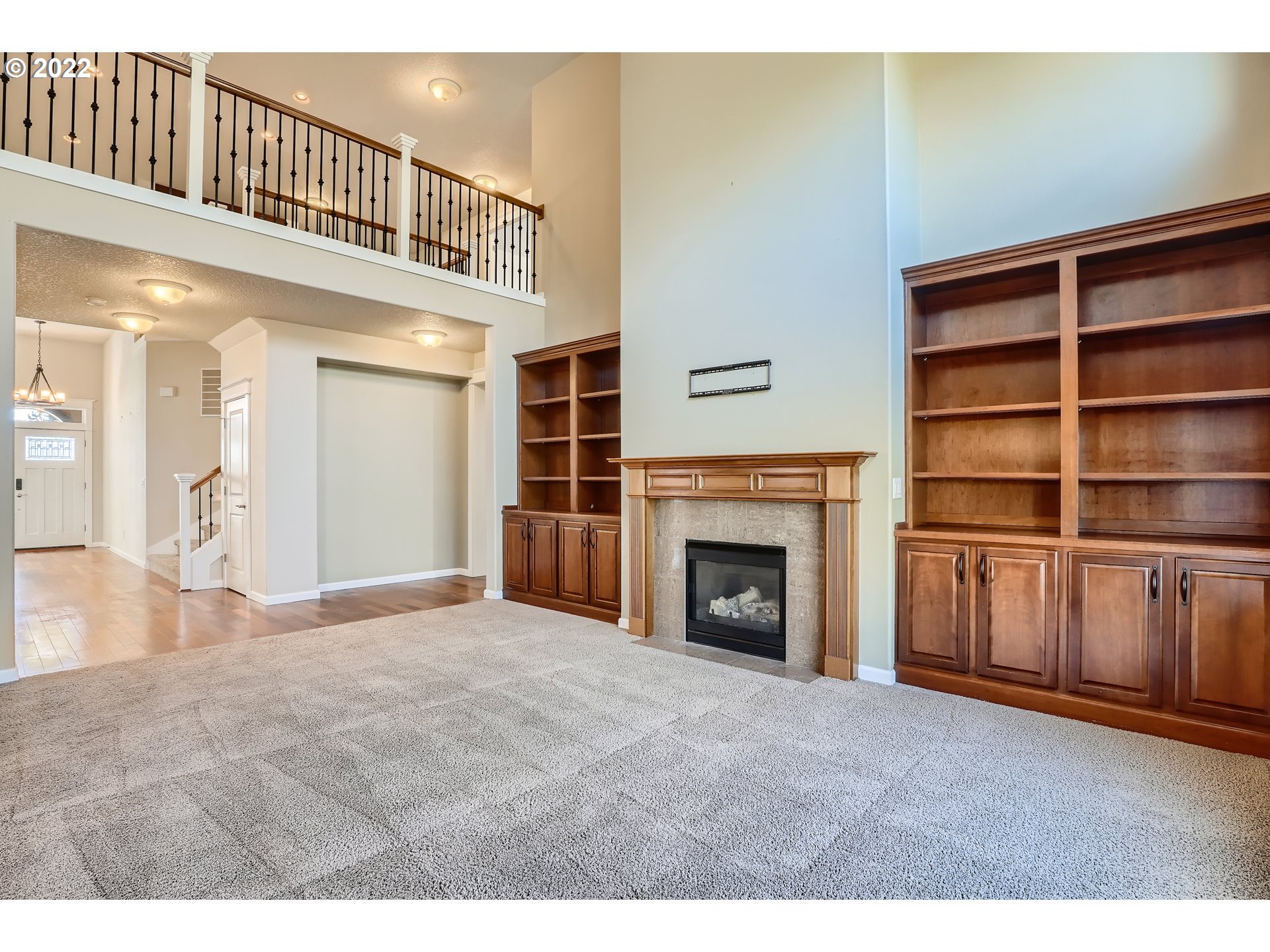 1652 South 15th Way Ridgefield, WA 98642 - Photo 10 of 32 a view of an empty room with a fireplace and a window