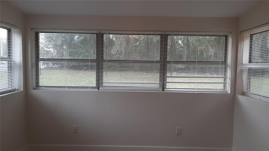 3801 Northwest 6th Street Gainesville, FL 32609 - Photo 13 of 19 a view of empty room with wooden floor and windows