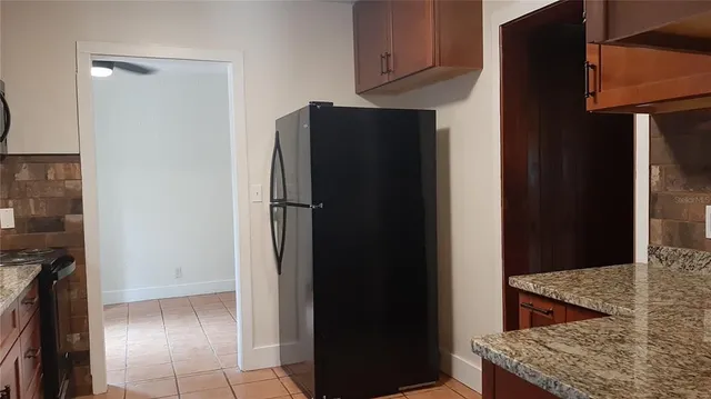 a kitchen with refrigerator and cabinets