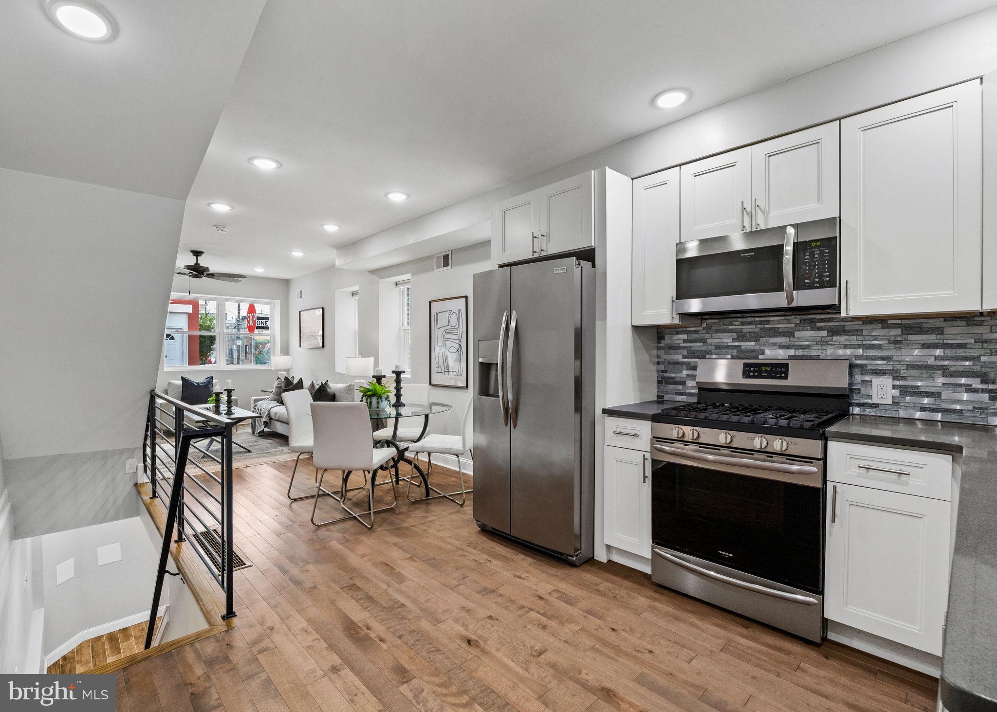 1800 Waterloo Street Philadelphia, PA 19122 - Photo 11 of 47 a kitchen with stainless steel appliances a stove a microwave a sink a refrigerator and cabinets