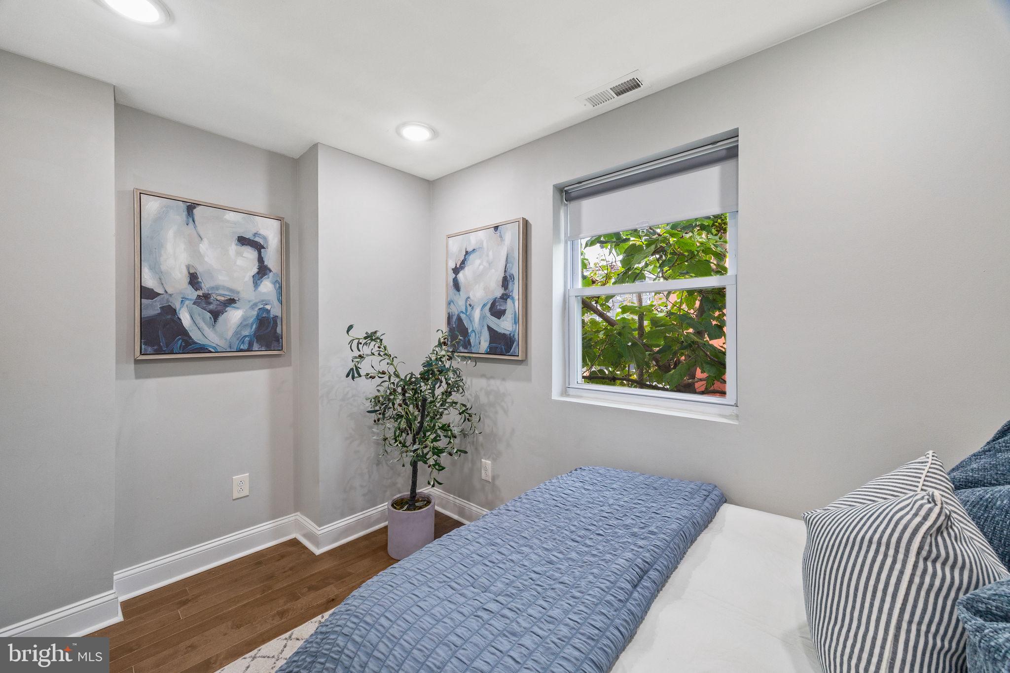1800 Waterloo Street Philadelphia, PA 19122 - Photo 26 of 47 a bedroom with a bed and a painting on the wall