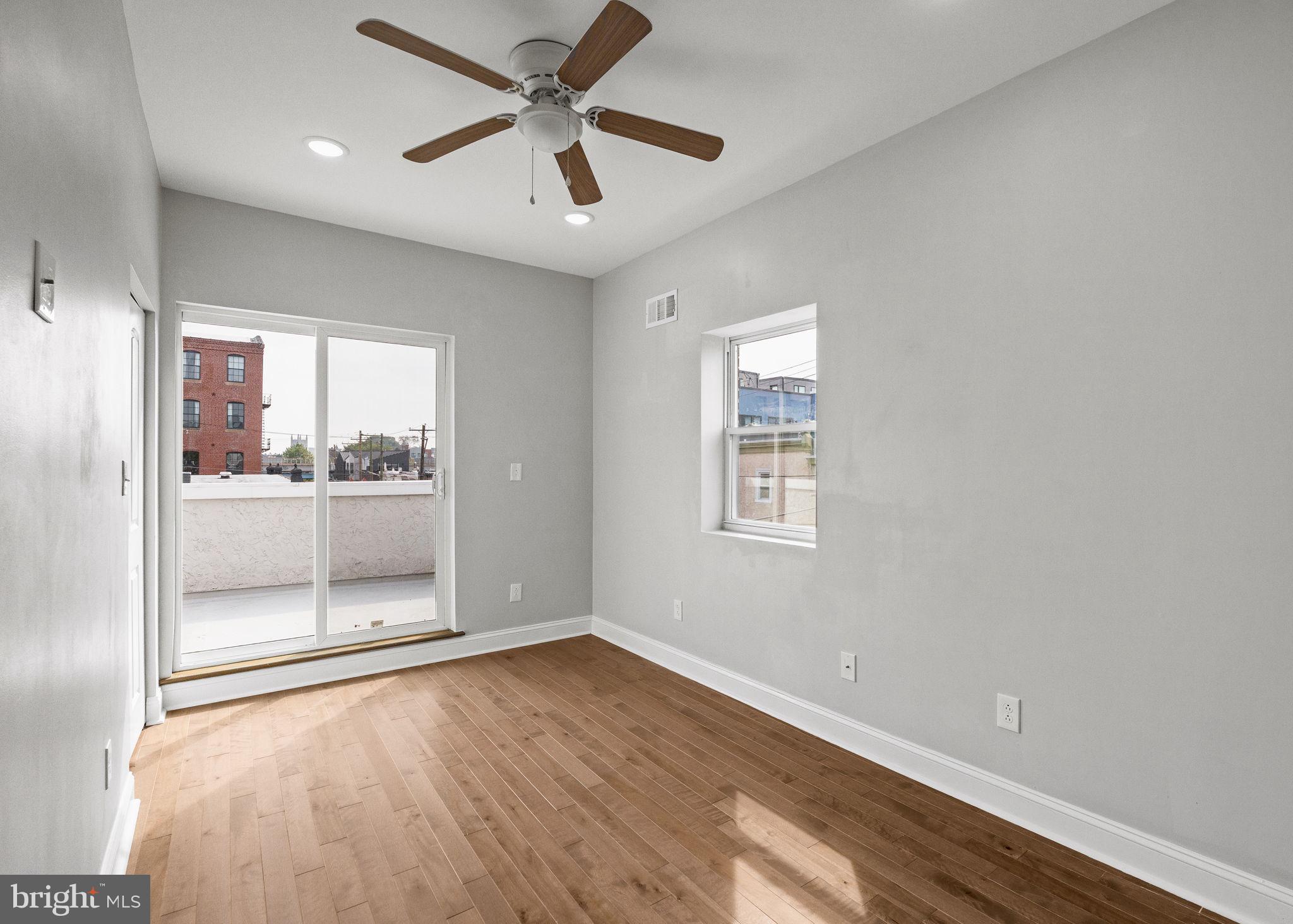 1800 Waterloo Street Philadelphia, PA 19122 - Photo 31 of 47 an empty room with wooden floor and windows
