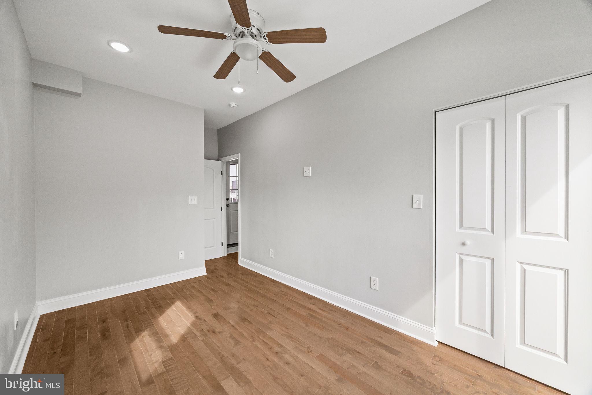 1800 Waterloo Street Philadelphia, PA 19122 - Photo 33 of 47 an empty room with wooden floor door and windows