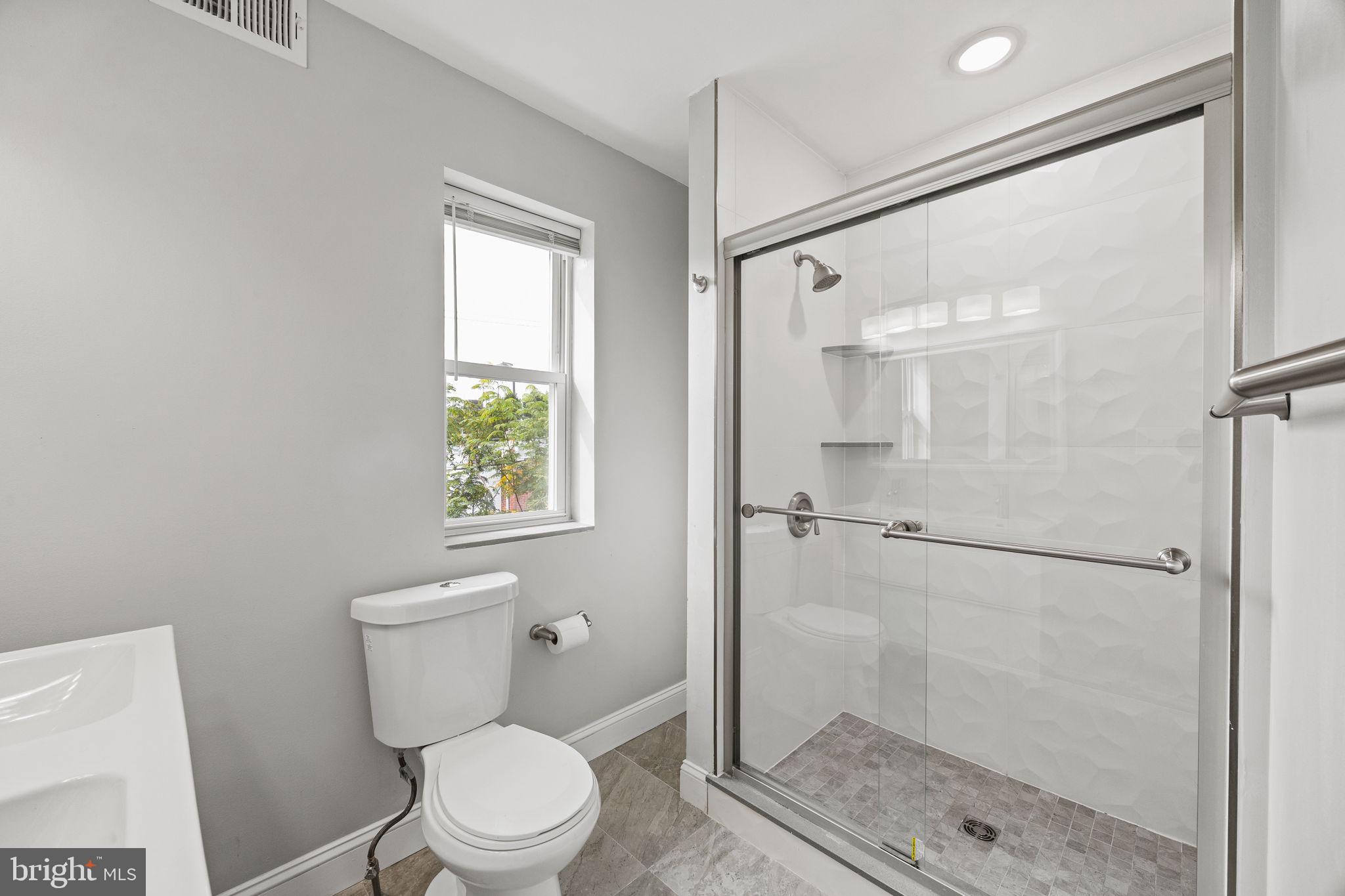 1800 Waterloo Street Philadelphia, PA 19122 - Photo 36 of 47 a white toilet sitting next to a bathroom sink