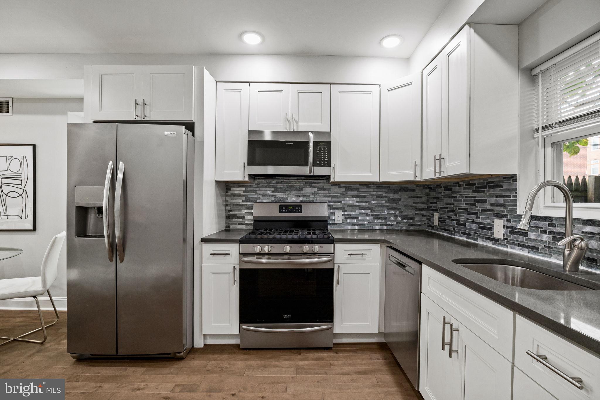 1800 Waterloo Street Philadelphia, PA 19122 - Photo 10 of 47 a kitchen with a refrigerator sink and microwave