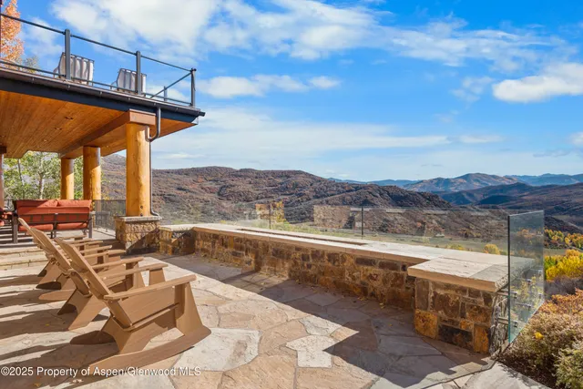 a bedroom with furniture and a large window