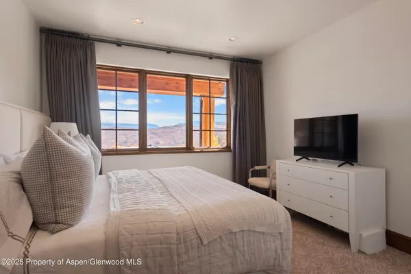 a view of a balcony with mountain view and a garden