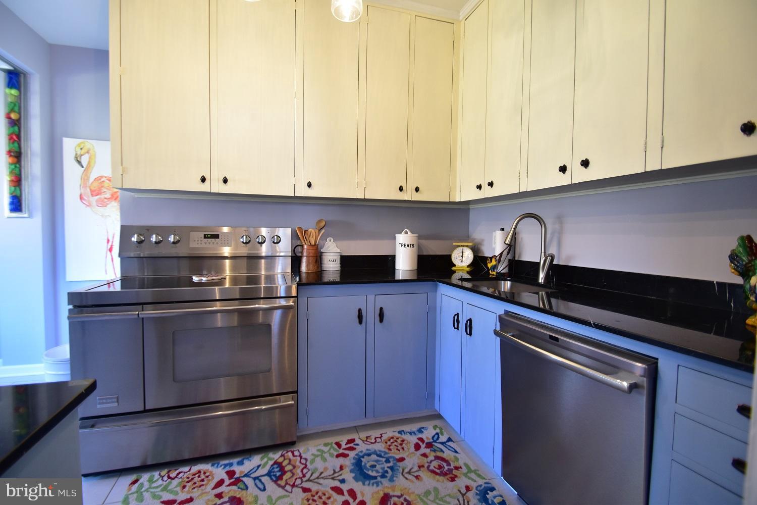 303 Rolling Rd. Baltimore, MD 21228 - Photo 14 of 21 a kitchen with stainless steel appliances granite countertop a sink stove and cabinets