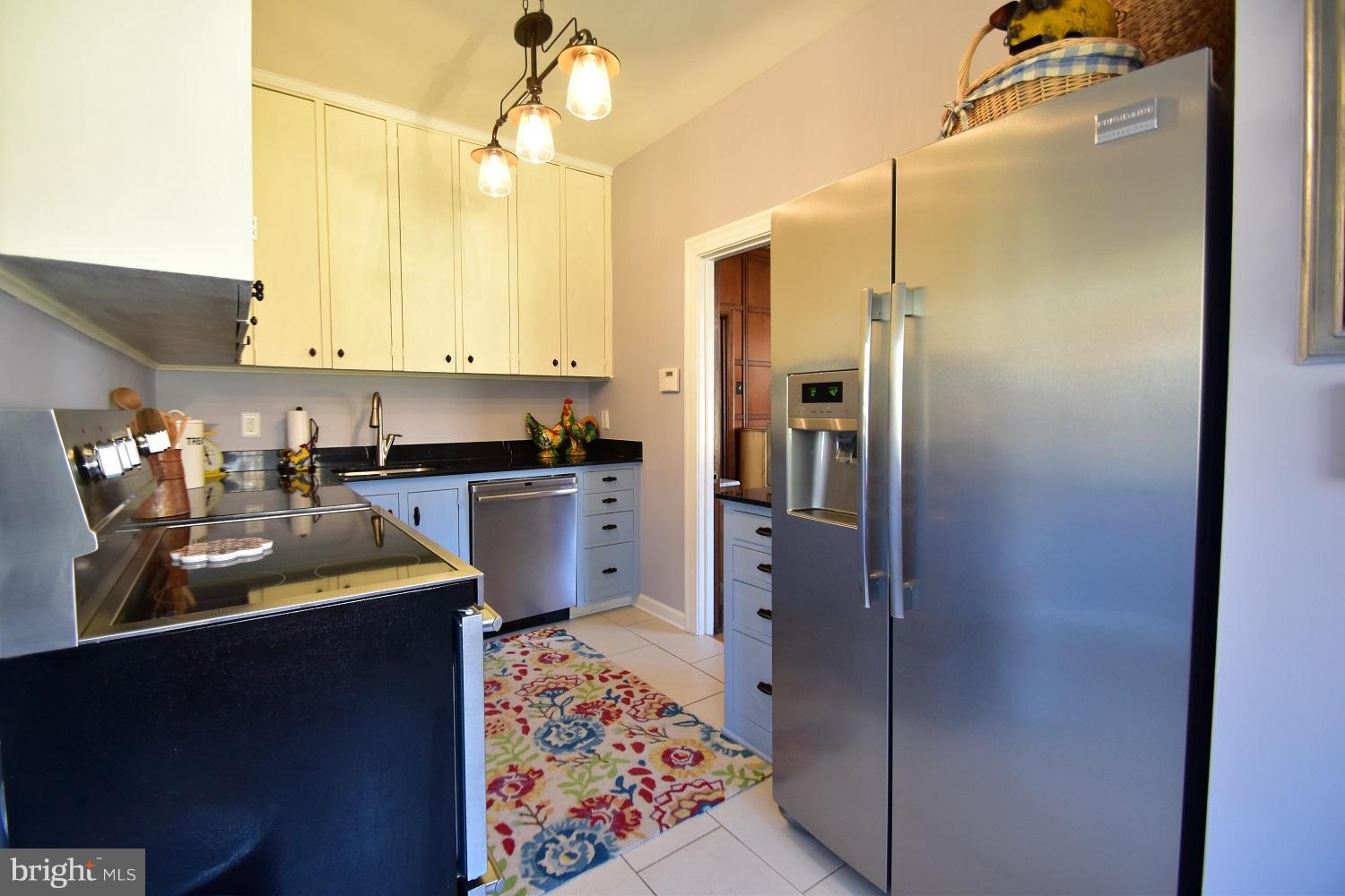 303 Rolling Rd. Baltimore, MD 21228 - Photo 15 of 21 a kitchen with stainless steel appliances granite countertop a refrigerator and a sink