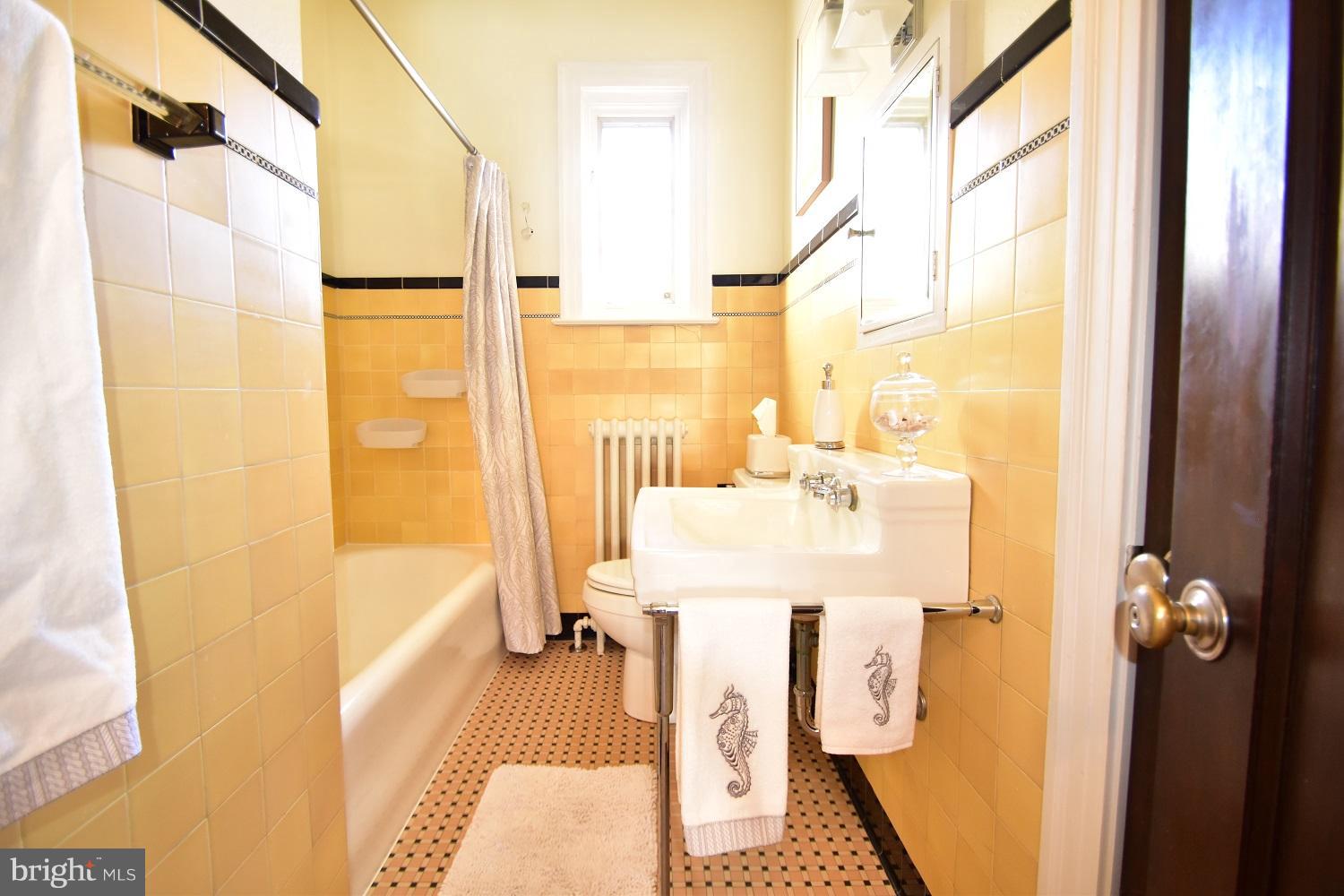 303 Rolling Rd. Baltimore, MD 21228 - Photo 20 of 21 a bathroom with a sink mirror and a shower