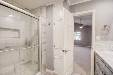 6906 Lovely Lane Austin, TX 78744 - Photo 13 of 20 a bathroom with a granite countertop shower sink and mirror